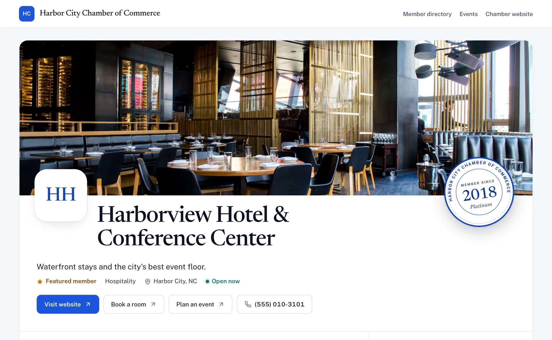 A member business's public profile page: cover photo, name, tagline, a Featured member badge, a Member since 2018 Platinum seal, open now, and buttons to visit the website, book a room, plan an event or call.